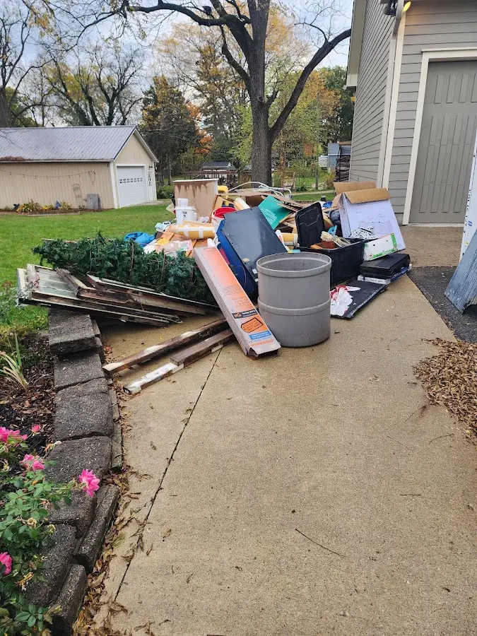 Dumpster being loaded with debris for Roofing Dumpster Rental in Portage
